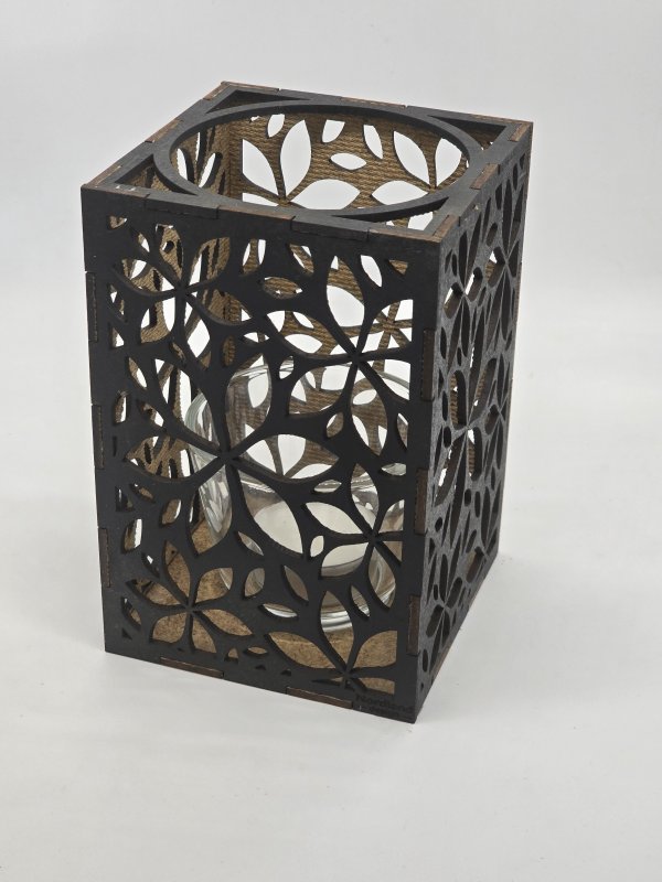 Ljuslyktan Lily i svart – handgjord trälykta med frostinspirerat mönster som sprider ett varmt och elegant ljus. Tillverkad i Sverige av Nordland Design.